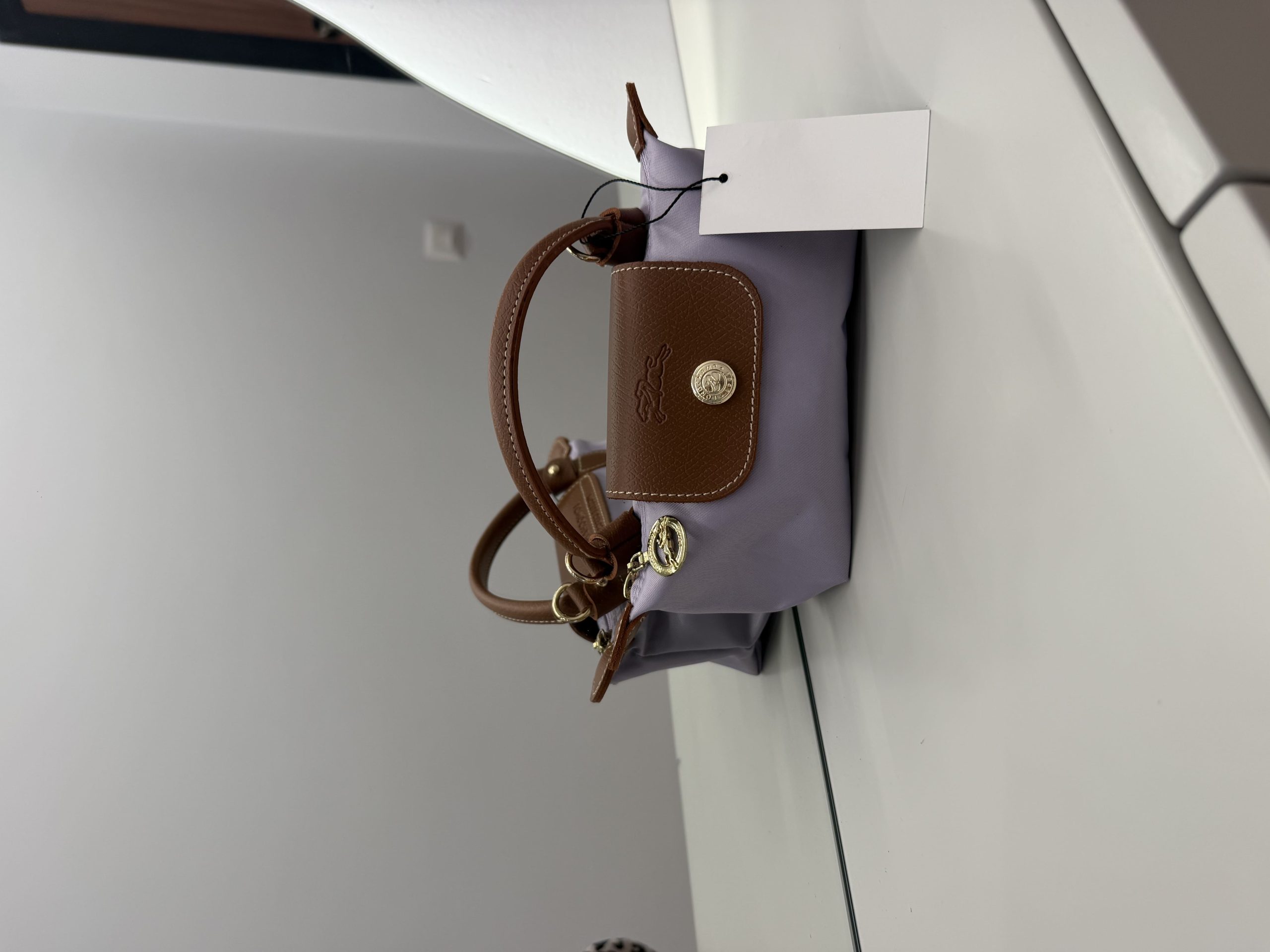 04_lilaecelet Çantë Longchamp Le Pliage Mini, elegant brown and lavender design.