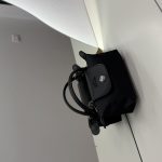 Black Longchamp Le Pliage Mini bag on white surface.