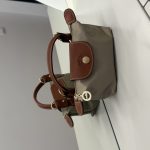 Çantë Longchamp Le Pliage Mini, brown leather trim, beige body.