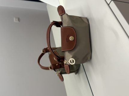 Çantë Longchamp Le Pliage Mini, brown leather trim, beige body.