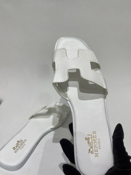 White Hermes sandals for women, elegant and stylish design.