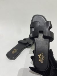 Black Hermes sandals for women, elegant and stylish design.