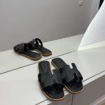 Hermes Oran canvas bicolor sandals on display, elegant women's footwear.