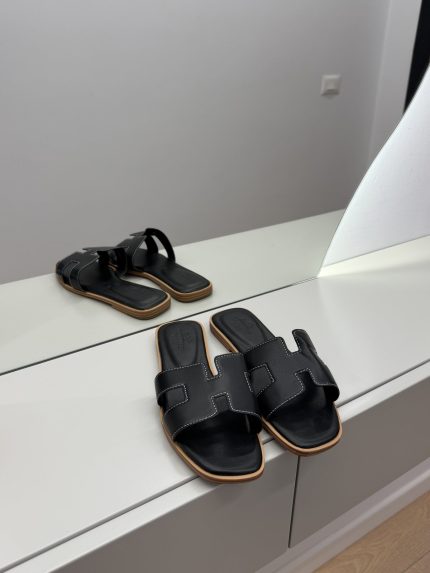 Hermes Oran canvas bicolor sandals on display, elegant women's footwear.