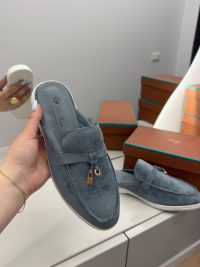 Loro Piana blue suede women's loafers with gold accents.