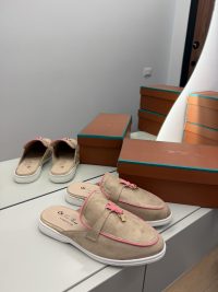Loro Piana women's exclusive beige loafers with pink accents on display.