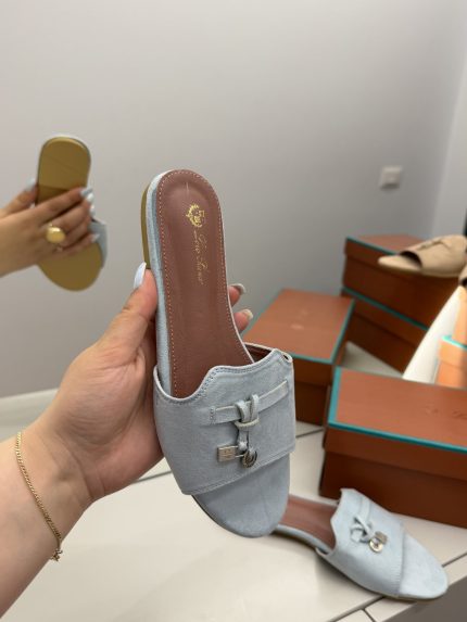 Shapka Loro Piana Slide Flat, elegant blue suede sandal with decorative buckle.
