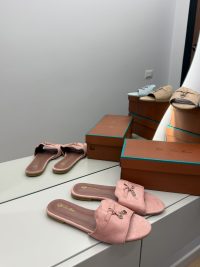 Pink Loro Piana slide flats with elegant design on display.