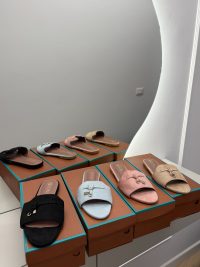 Shapka Loro Piana Slide Flats in multiple colors on display.