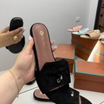 Black Shapka Loro Piana slide flat with elegant design on display.