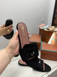 Black Shapka Loro Piana slide flat with elegant design on display.