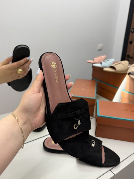 Black Shapka Loro Piana slide flat with elegant design on display.
