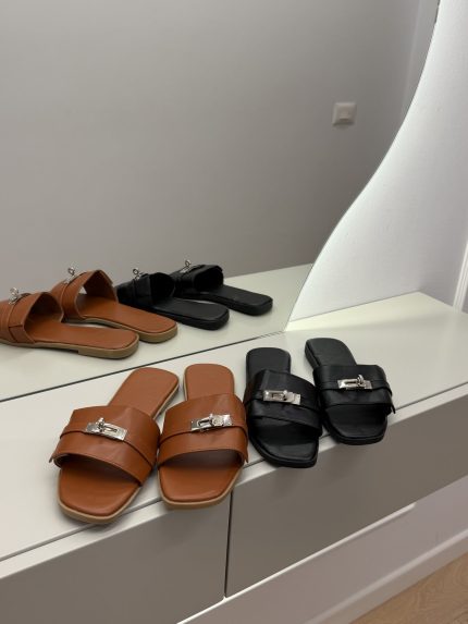 Louis Vuitton brown and black mules on display.