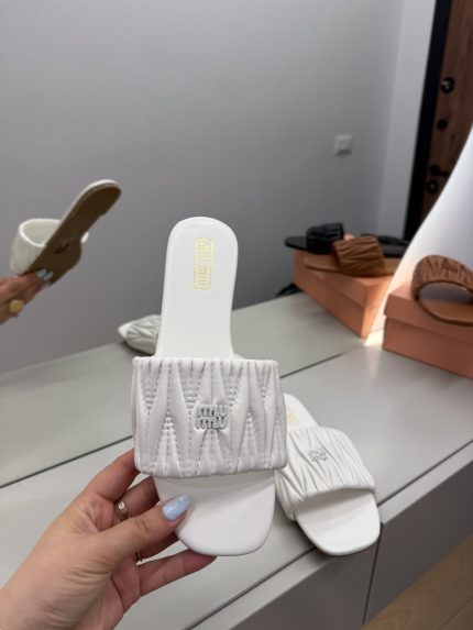 White Miu Miu Matelassé women's slide sandal on display.