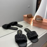 Miu Miu Matelasse women's sandals in black and brown on display.
