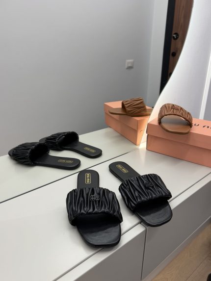 Miu Miu Matelasse women's sandals in black and brown on display.