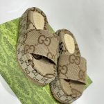 Gucci GG monogram slides on green patterned box for women.