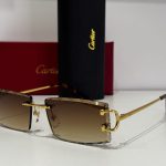 Cartier sunglasses with gold frame and gradient lenses, elegant design.