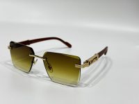 Luxury Cartier sunglasses with gold accents and brown gradient lenses.