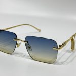 Cartier sunglasses with gold frame and gradient lenses.