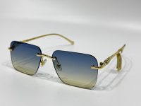 Cartier sunglasses with gold frame and gradient lenses.
