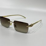 Luxury Cartier sunglasses with gold frame and gradient lenses.