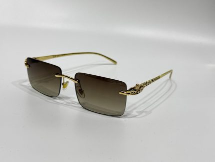 Luxury Cartier sunglasses with gold frame and gradient lenses.