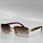 Cartier sunglasses with gold accents and brown gradient lenses.