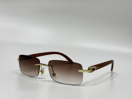 Cartier sunglasses with gold accents and brown gradient lenses.