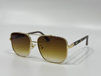 Gold-framed Dita sunglasses with gradient lenses on white background.