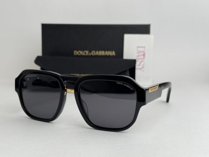 Dolce & Gabbana sunglasses with black frames and branded packaging.