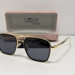 Gucci sunglasses with gold frame and black lenses in case.