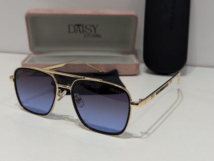 Gucci sunglasses with gold frame and gradient lenses in case.