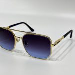Gucci sunglasses with gold frame and gradient lenses.