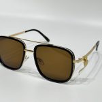 Men's Louis Vuitton sunglasses with gold accents and brown lenses.