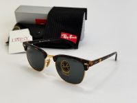 Ray-Ban sunglasses with case and packaging on display.
