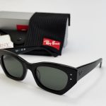 Ray-Ban sunglasses with case and cleaning cloth displayed.