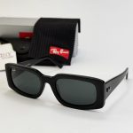 Ray-Ban sunglasses with black frame and accessories displayed.