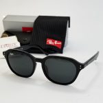 Ray-Ban sunglasses with case and cleaning cloth displayed elegantly.