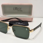 Ray-Ban sunglasses with gold frame and green lenses in case.
