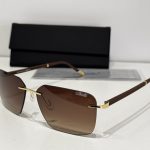 Men's Silhouette sunglasses, brown lenses, gold accents, stylish protection.