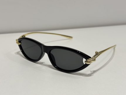 Bottega Veneta cat-eye sunglasses, black frame, gold accents, elegant design.