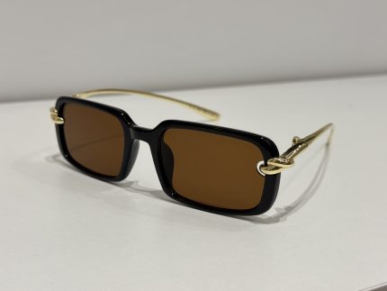 Bottega Veneta sunglasses with black frames and gold temples.