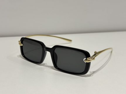 Bottega Veneta sunglasses with black frames and gold temples.