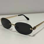 BVLGARI Serpenti sunglasses with gold accents and dark lenses.