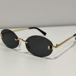 Cartier rimless sunglasses with gold temples on white background.