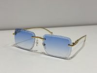 Textured square Cartier sunglasses with blue gradient lenses and gold frames.