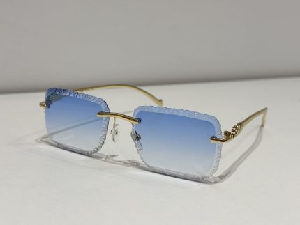 Textured square Cartier sunglasses with blue gradient lenses and gold frames.