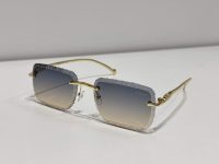 Textured square Cartier sunglasses with gold frames on white background.