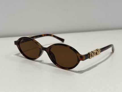 Dior oval sunglasses, elegant tortoiseshell design for women.